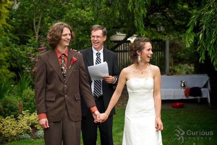 bride groom and minister laughing