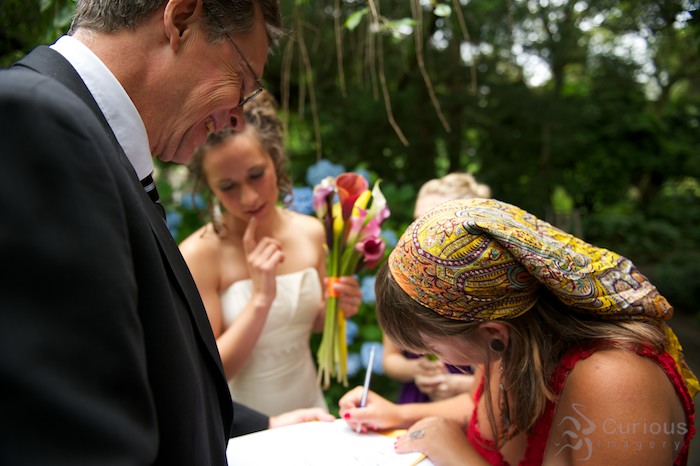 bridesmaid signing as witness on marriage license