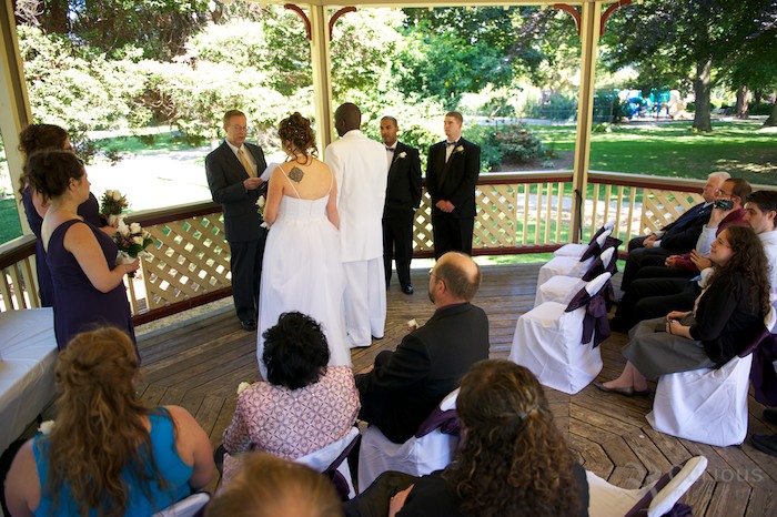 bride and groom getting married in gazebo