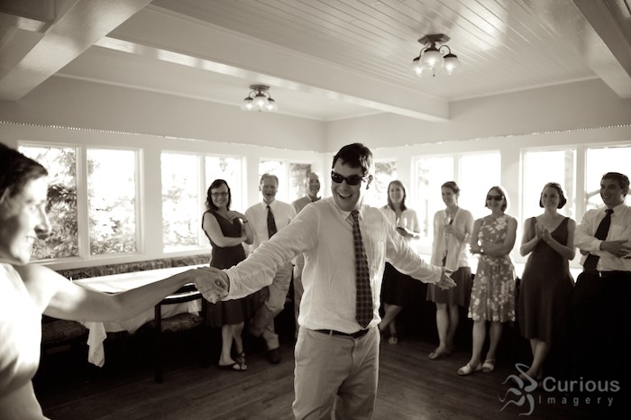 groom having fun dancing with bride at willows in, black and white