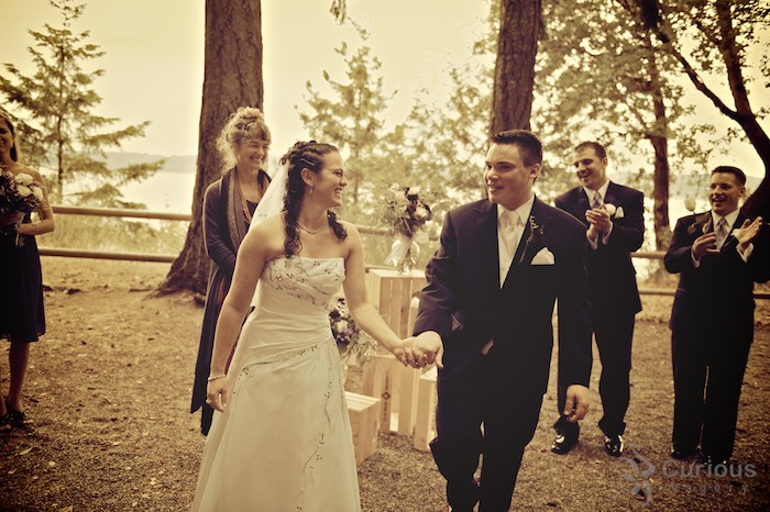 enthusiasitc bride and groom lead recessional. antique cross processed color.
