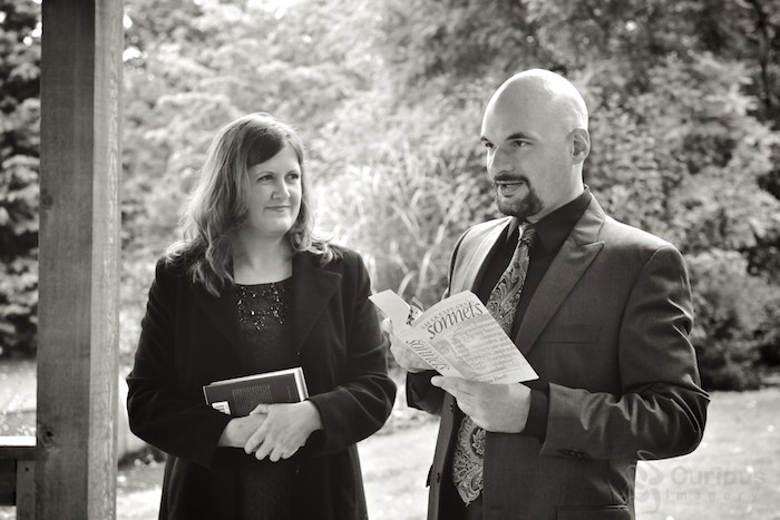 bride and groom exchange vows at Evergreen Arboretum and Gardens in Everett. Groom reads Shakespeare sonnette