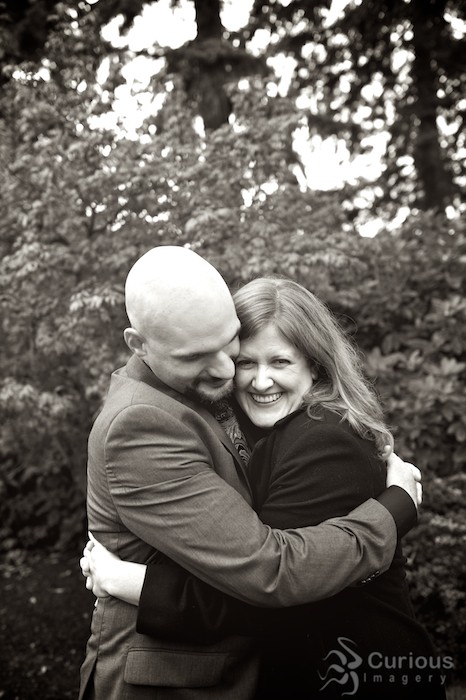Bride and groom embrace in Evergreen Arboretum and Gardens in Everett, low-contrast B&W